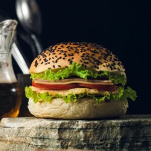 Delicious gourmet sandwich with fresh lettuce and tomato on sesame seed bun, styled for food photography.